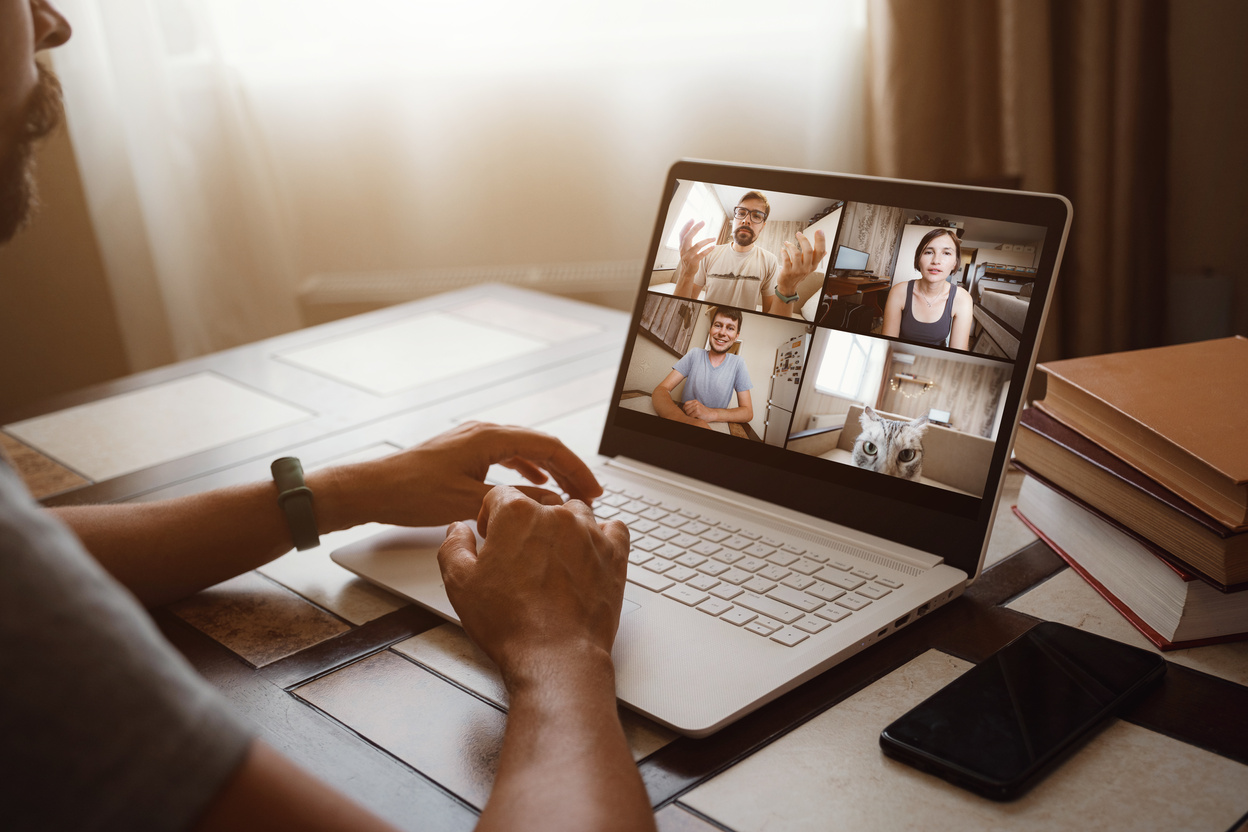 Man Working From Home Having Online Group Videoconference On Laptop